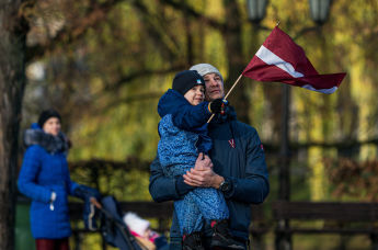 Мальчик держит в руках флаг Латвии