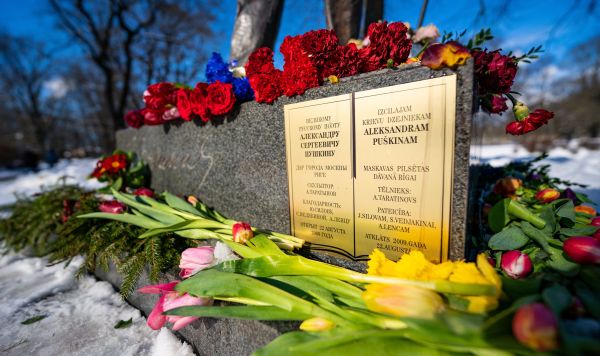 Цветы у памятника поэту Александру Сергеевичу Пушкину в парке Кронвалда в Риге, Латвия