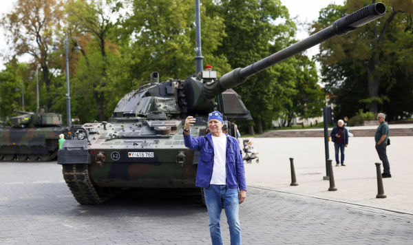 Мужчина делает селфи у немецкого танка перед официальным открытием немецкой бригады для восточного фланга НАТО в центре Вильнюса, Литва