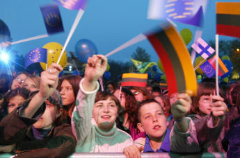 Литовцы размахивают флагами на концерте, посвященном вступлению Литвы в ЕС, в центре Вильнюса, Литва, 2004 год
